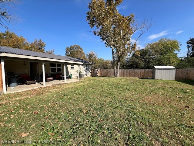 view of yard featuring a storage unit and a patio