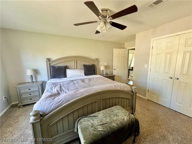 carpeted bedroom with ceiling fan and a closet