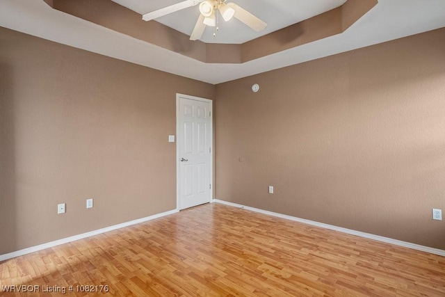 3707 Princeton Ct, Van Buren, AR 72956 - unfurnished room with light wood-type flooring, ceiling fan, and a tray ceiling