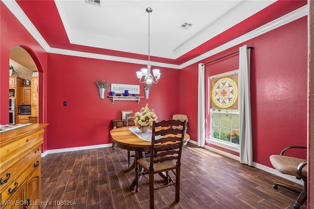 dining room featuring a raised ceiling, baseboards, dark wood-style floors, and visible vents
