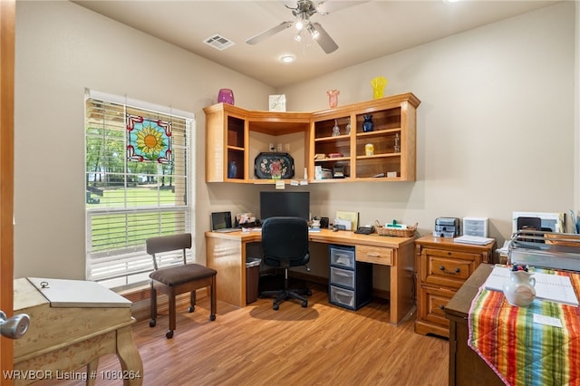 home office with light wood-style floors, visible vents, and ceiling fan