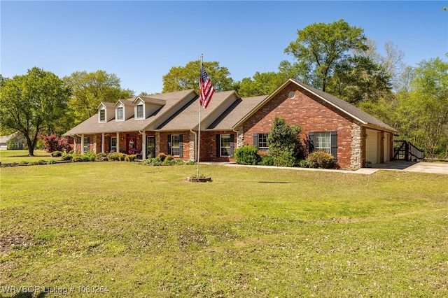 cape cod house with a garage, brick siding, driveway, and a front lawn