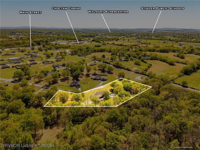 birds eye view of property featuring a wooded view