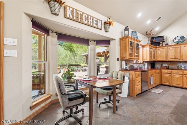interior space featuring visible vents, glass insert cabinets, dishwasher, dark countertops, and high vaulted ceiling