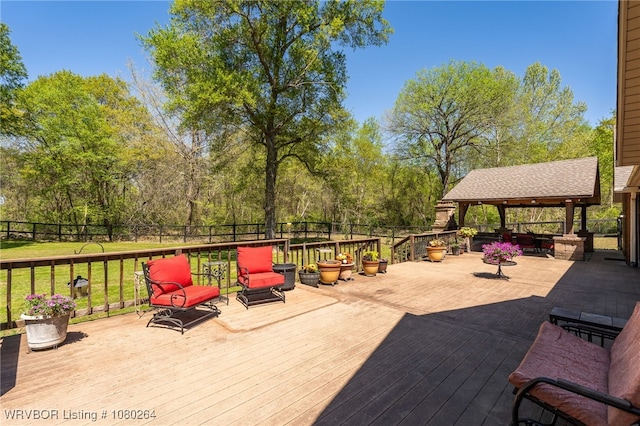 deck with a gazebo, fence, and a lawn