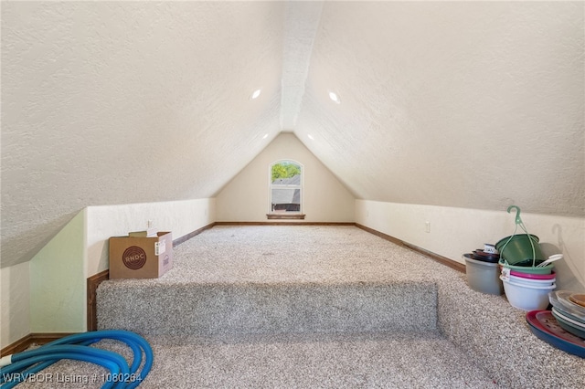bonus room with baseboards, vaulted ceiling, and a textured ceiling