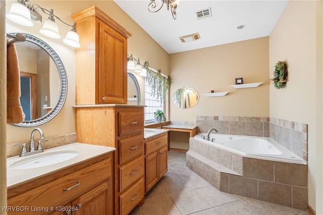 bathroom with tile patterned floors, vanity, visible vents, and a bath