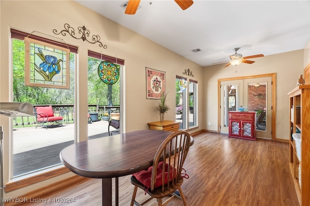 dining space with visible vents, wood finished floors, and ceiling fan