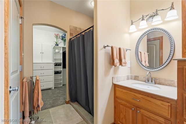 bathroom featuring tile patterned floors, vanity, and a shower with curtain