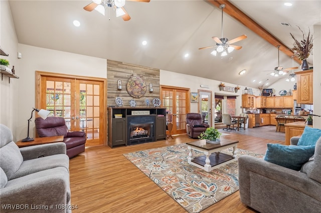 living area featuring french doors, high vaulted ceiling, and a ceiling fan