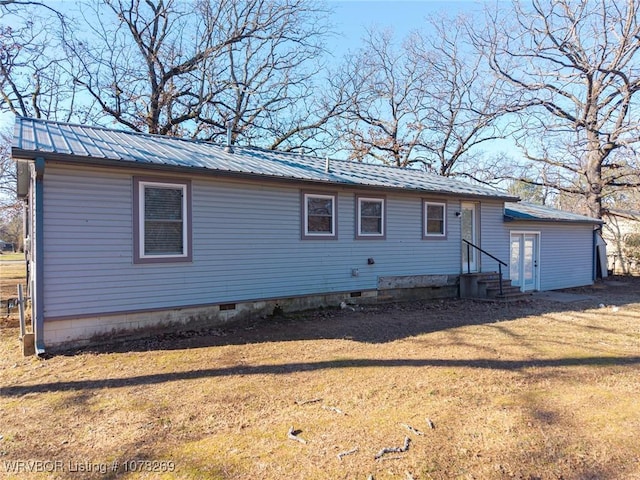 rear view of property featuring a yard