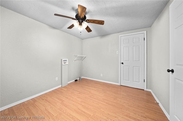 laundry area with ceiling fan, washer hookup, a textured ceiling, and light hardwood / wood-style floors