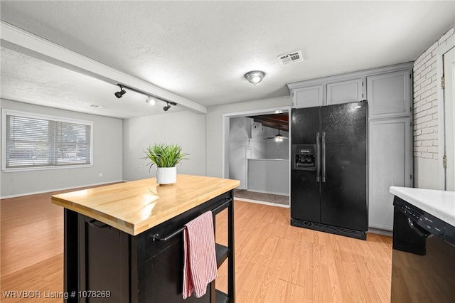 kitchen with gray cabinetry, black appliances, a textured ceiling, wood counters, and light wood-type flooring