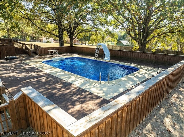 view of swimming pool with a water slide