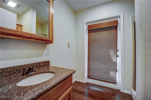 bathroom with vanity and wood-type flooring