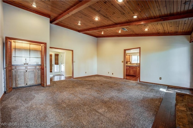 interior space with lofted ceiling with beams, wooden ceiling, and sink