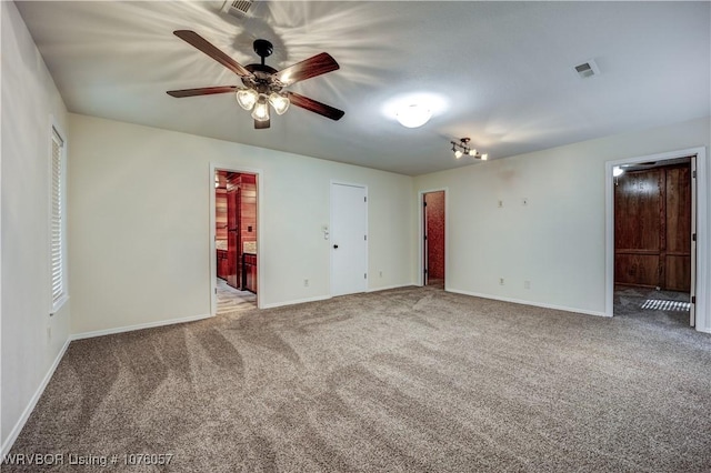 unfurnished bedroom with carpet, ceiling fan, and ensuite bath