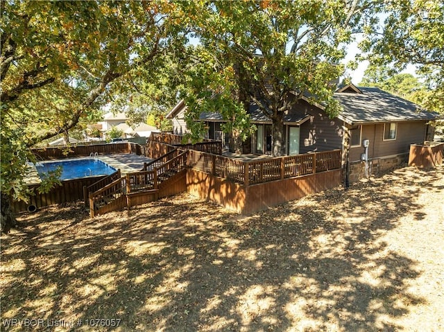 back of property with a swimming pool side deck