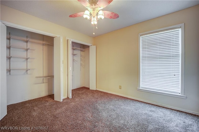 unfurnished bedroom with carpet, a closet, and ceiling fan