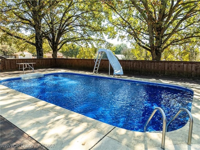 view of pool with a water slide