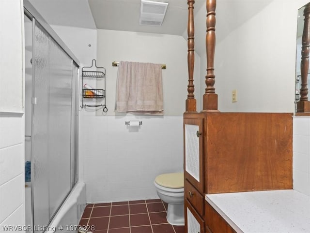 bathroom with shower / bath combination with glass door and toilet