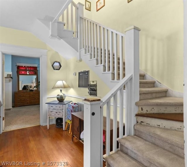 stairs with wood-type flooring