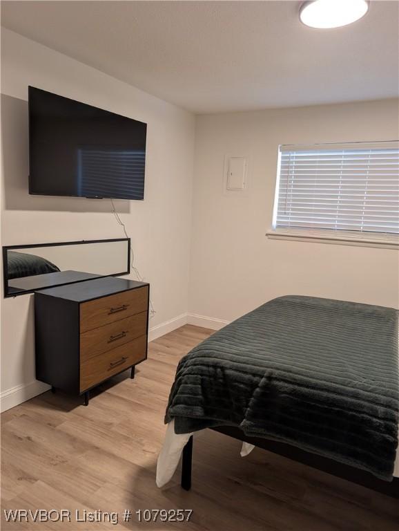 bedroom featuring light wood-type flooring and baseboards