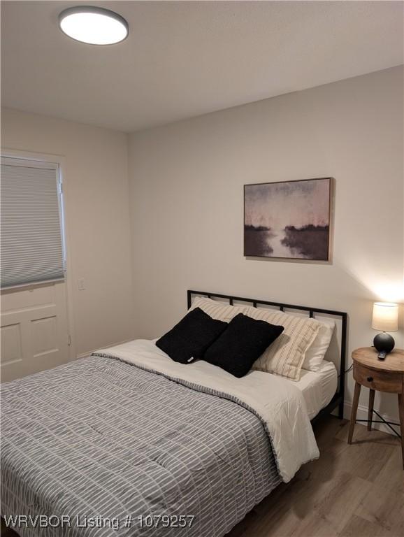 bedroom with wood finished floors