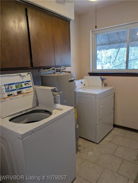 laundry room featuring cabinet space, electric water heater, and independent washer and dryer