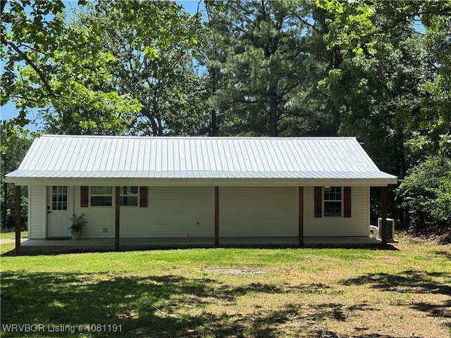 469497 975th Rd, Sallisaw, OK 74955 - view of side of property with a porch, a lawn, metal roof, and central air condition unit