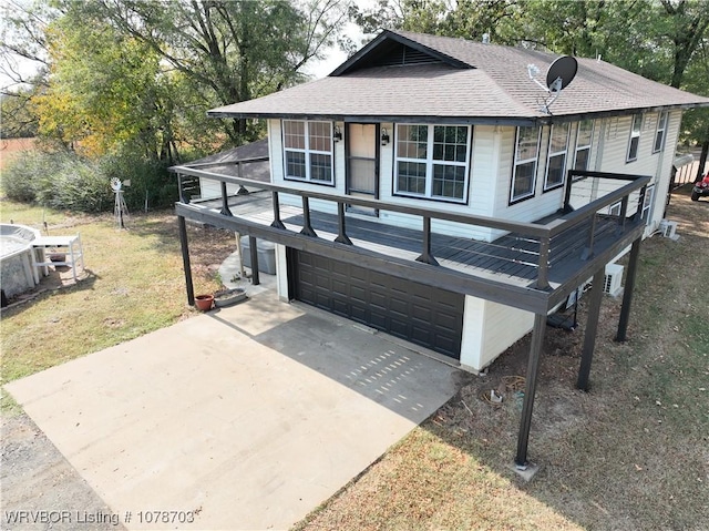 view of front of home with a garage and a front lawn