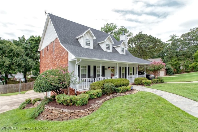 cape cod home featuring a front lawn and a porch