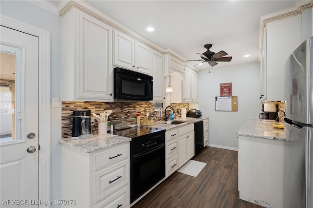 kitchen featuring black appliances, decorative backsplash, dark wood-style floors, white cabinetry, and a sink