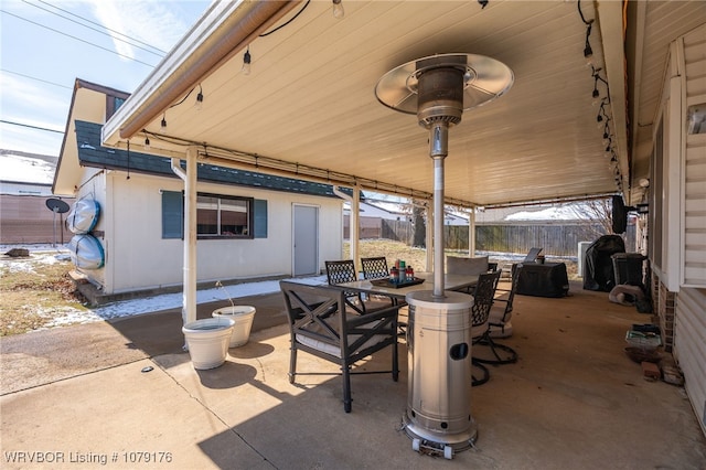 view of patio with outdoor dining space and fence