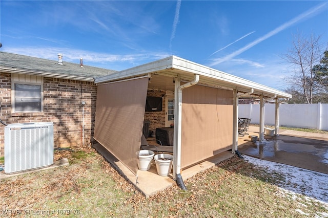 exterior space with central AC unit and fence