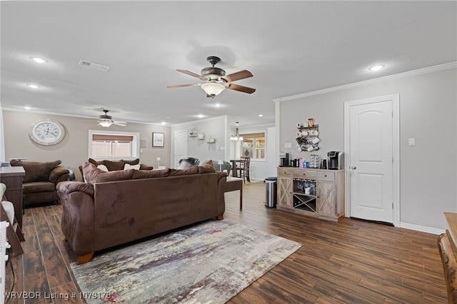 living area featuring baseboards, visible vents, recessed lighting, ornamental molding, and dark wood-type flooring