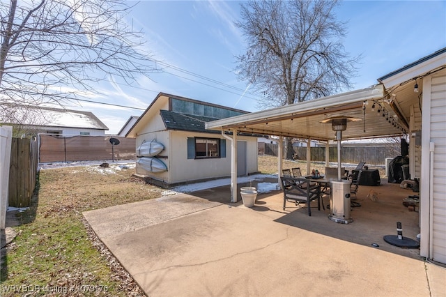 view of patio / terrace with an outdoor structure, outdoor dining area, and a fenced backyard