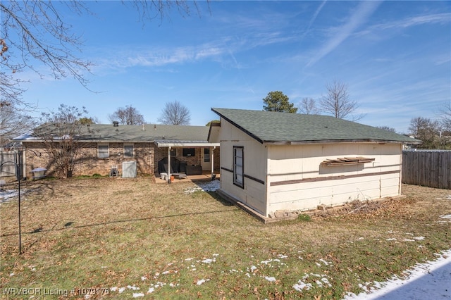 rear view of house with a patio, a yard, and fence