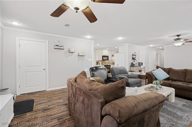 living area featuring visible vents, a ceiling fan, crown molding, and wood finish floors