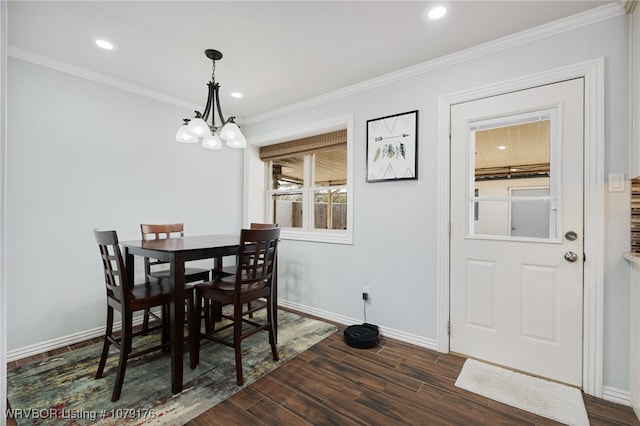 dining space featuring a notable chandelier, dark wood-type flooring, baseboards, and ornamental molding