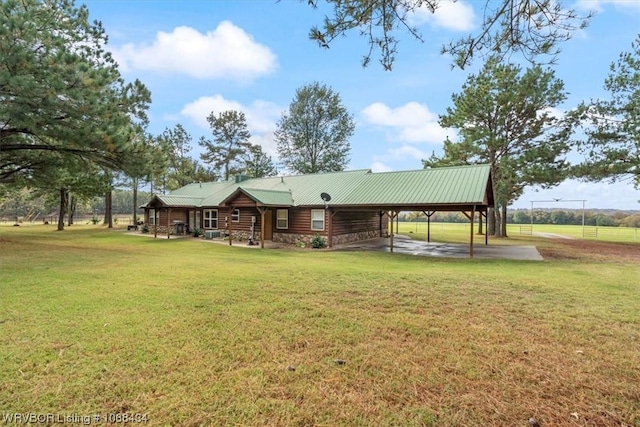 exterior space with a carport and a yard