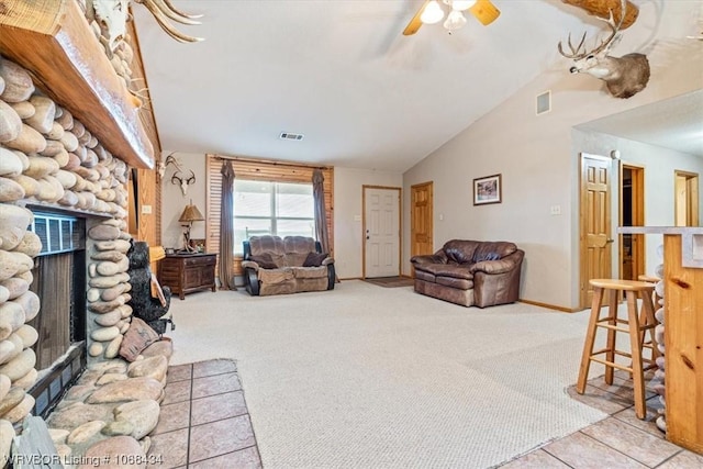 carpeted living room with ceiling fan, a fireplace, and vaulted ceiling