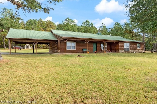 back of property with a carport and a lawn