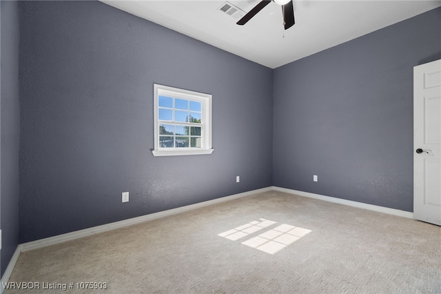 carpeted spare room featuring ceiling fan