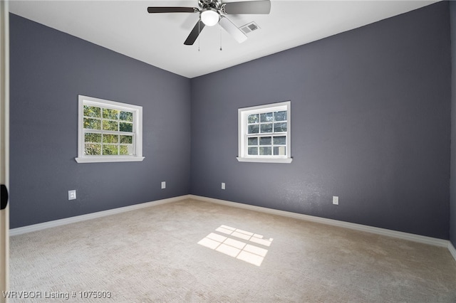 spare room with light carpet and ceiling fan