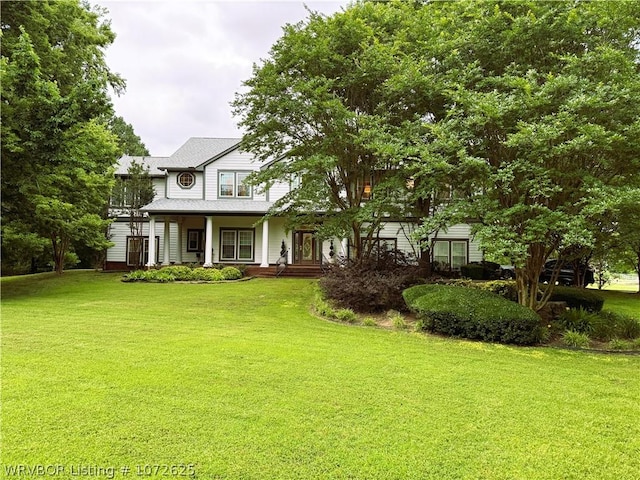 view of front of property with a front yard and covered porch