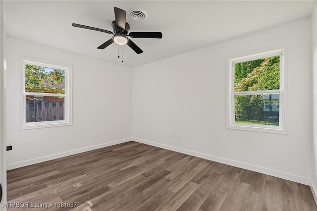 123 Oak St, Alma, AR 72921 - spare room featuring plenty of natural light, wood finished floors, and ceiling fan