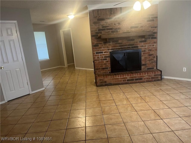 1505 6th Ter, Barling, AR 72923 - unfurnished living room with light tile patterned floors, a fireplace, a textured ceiling, and ceiling fan