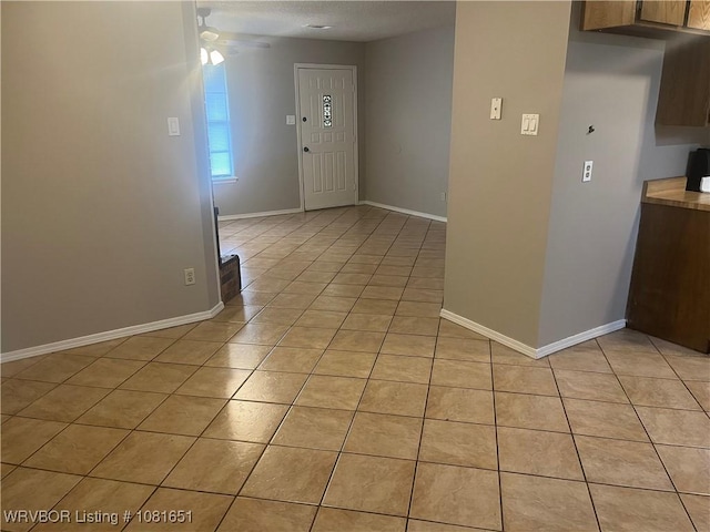 1505 6th Ter, Barling, AR 72923 - spare room featuring light tile patterned floors and a ceiling fan