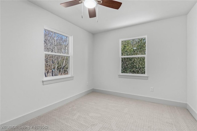 carpeted spare room with ceiling fan